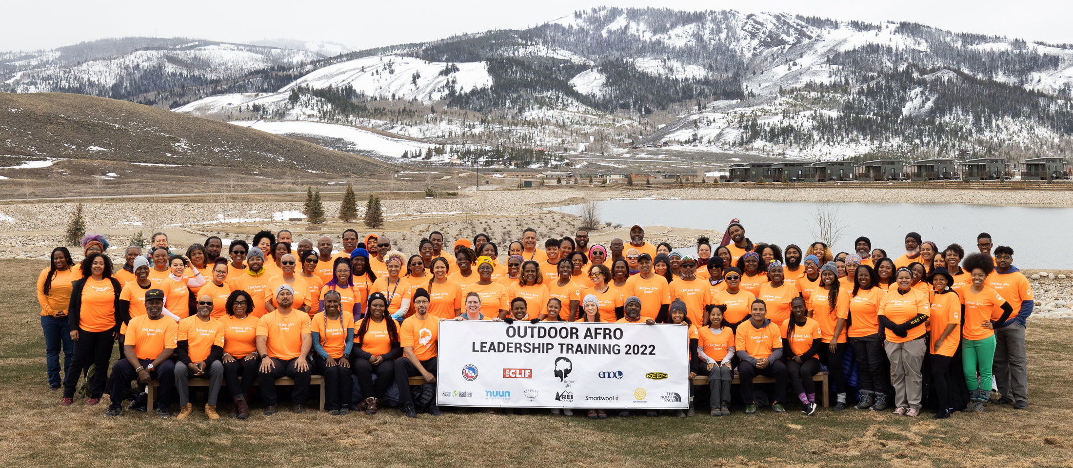 Group photo of the Outdoor Afro leadership training members posing in front of mountains. Visit https://outdoorafro.org/